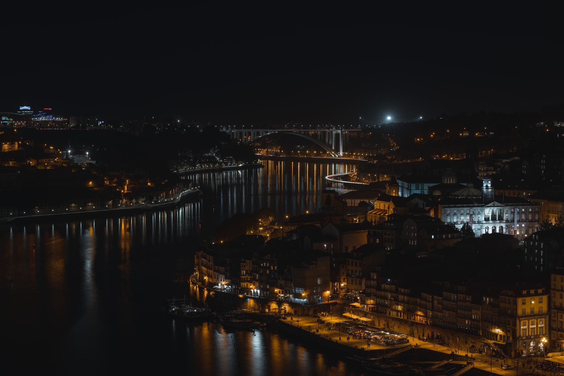 A river city at night, bridges and streets picked out in light